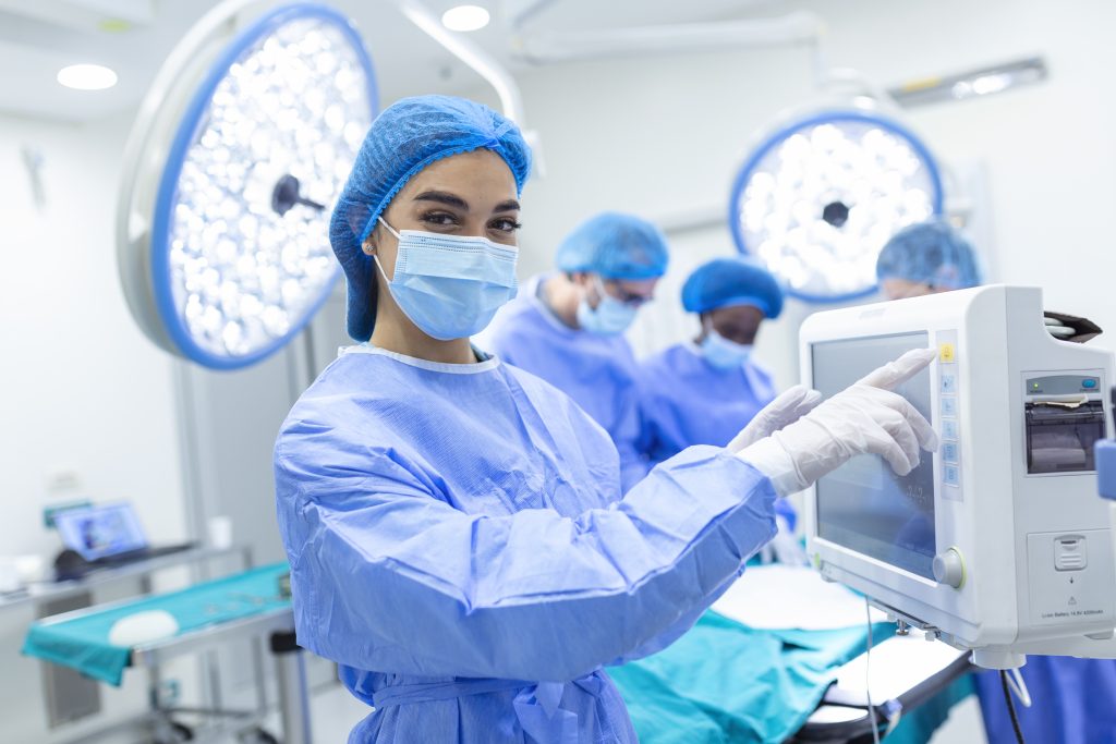 anesthesiologist keeping track vital functions body during cardiac surgery surgeon looking medical monitor during surgery doctor checking monitor patient health status