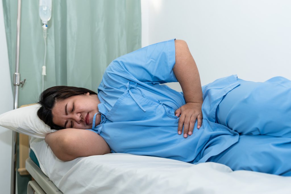 woman patient lying patient s bed she had severe abdominal pain from gastritis enteritis