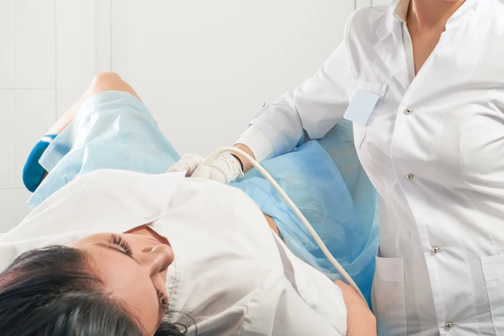 gynecologist doing ultrasound scanning pregnant woman