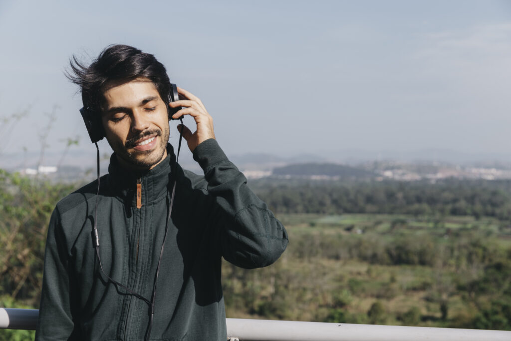 man enjoying music with eyes closed