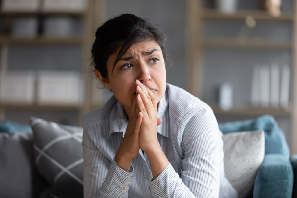 sad indian woman feels miserable desperate sit sofa look out window thinking about personal troubles does see way out difficult life situation break up heartbreak cheated girl concept